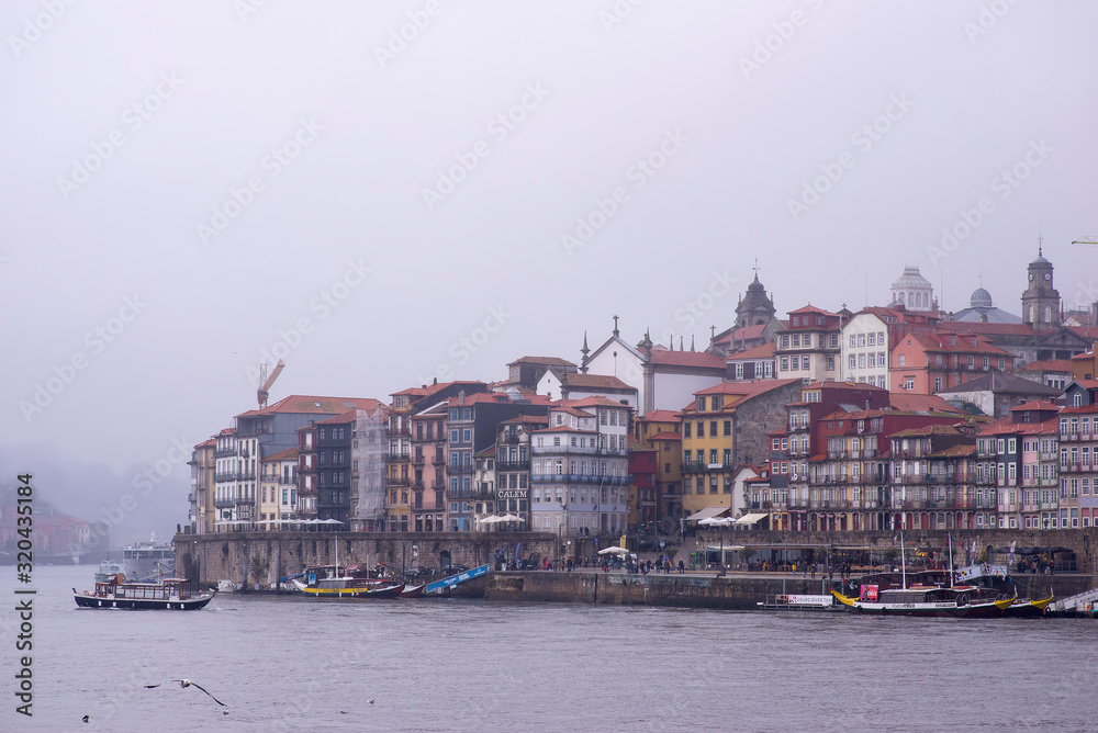 December 8, 2019 Porto, Portugal. People and cars crossing the port of Porto a day of rain and fog