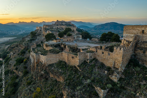Aerial sunset view of Sagunto, huge fortress stretching across the mountain range north of Valencia Spain © tamas