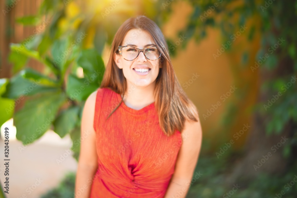 Young beautiful girl smiling happy and confident walking at the town park, standing with a smile on face Young beautiful girl smiling happy and confident walking at the town park, standing with a smile on face