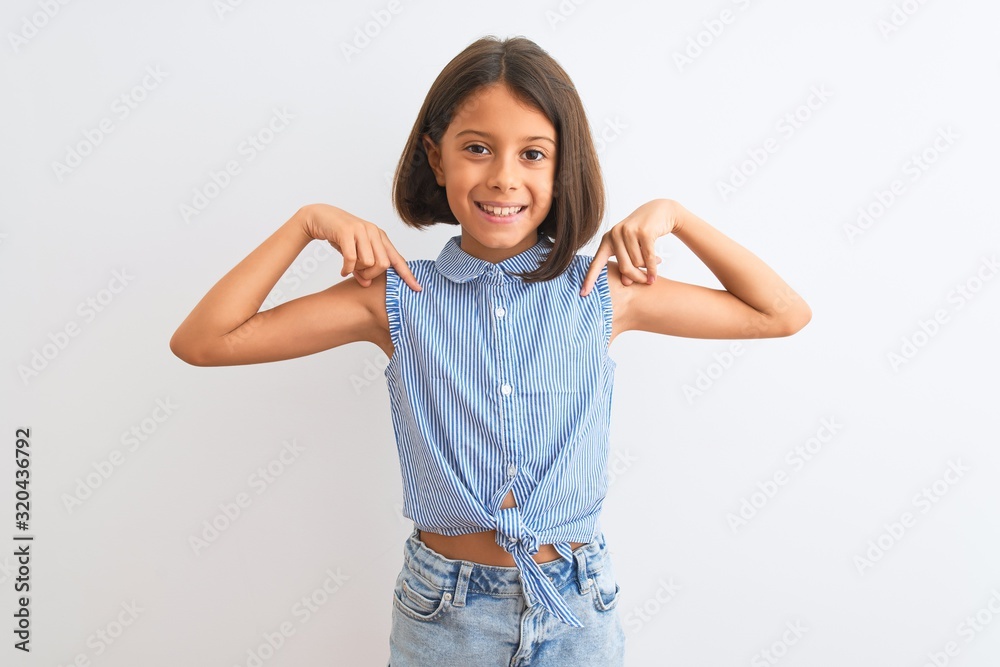 Young beautiful child girl wearing blue casual shirt standing over isolated white background looking confident with smile on face, pointing oneself with fingers proud and happy. Young beautiful child girl wearing blue casual shirt standing over isolated white background looking confident with smile on face, pointing oneself with fingers proud and happy.