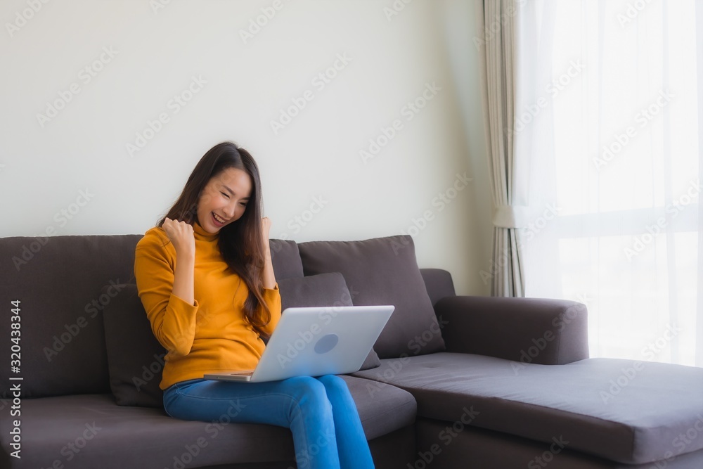 Portrait young asian woman using laptop computer note book on sofa Portrait young asian woman using laptop computer note book on sofa