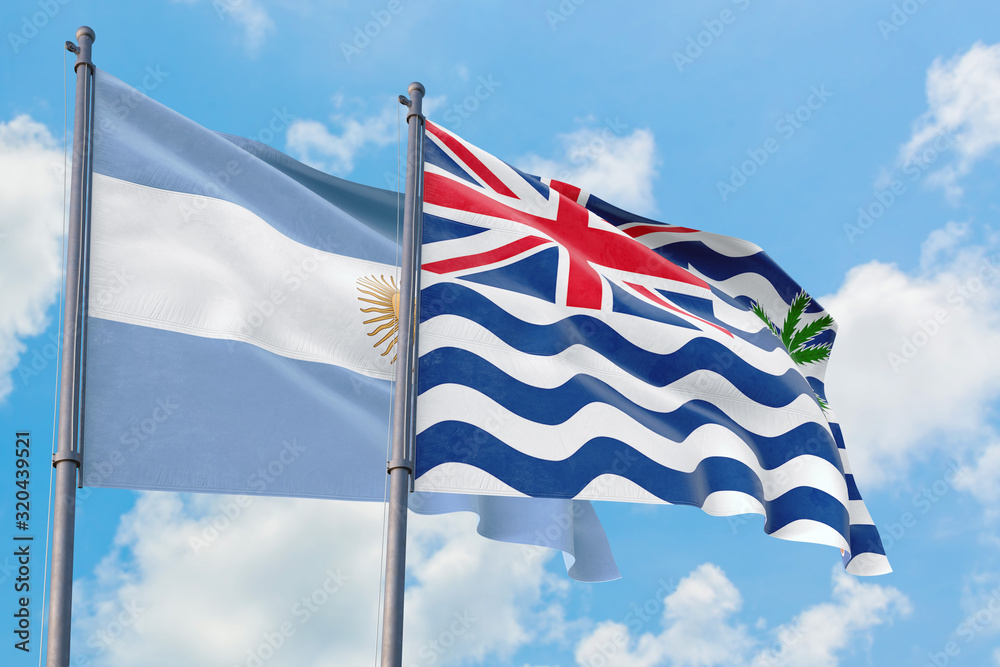British Indian Ocean Territory and Argentina flags waving in the wind against white cloudy blue sky together. Diplomacy concept, international relations.