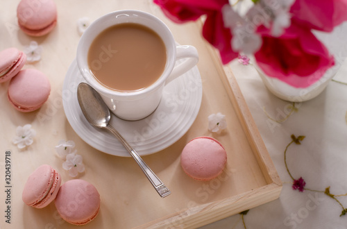 Coffee or Tea in White Cup with Silver Spoon on a Wooden Serving Tray with Pink Flowers and Cookies