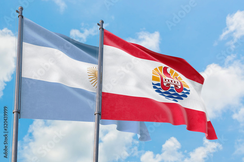 French Polynesia and Argentina flags waving in the wind against white cloudy blue sky together. Diplomacy concept, international relations.