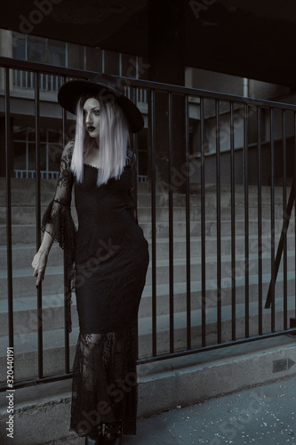 Young female in the stylish Gothic costume and make up outside.