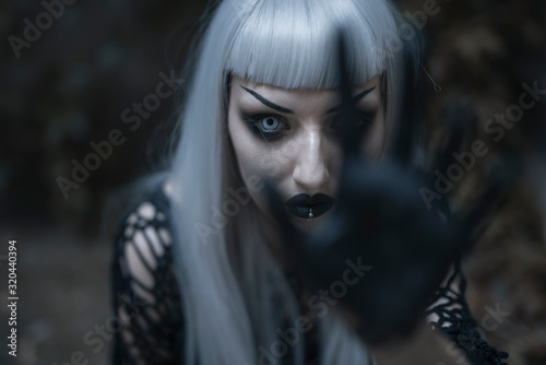 Dark beautiful gothic enchantress standing outdoor Fototapet