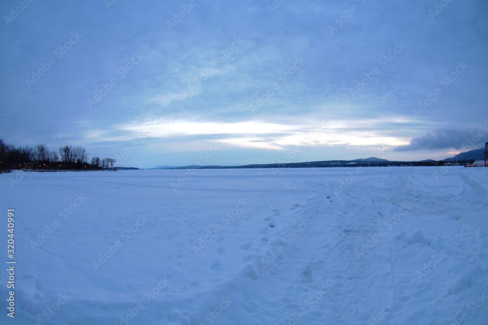frozen lake winter landscape ice and snow dusk