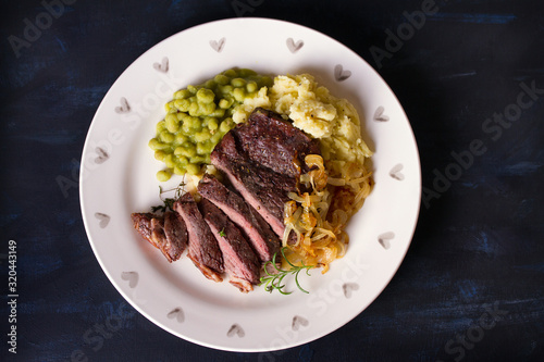 Beef steak fillet with mash on plate. Overhead horizontal image