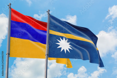 Nauru and Armenia flags waving in the wind against white cloudy blue sky together. Diplomacy concept, international relations.