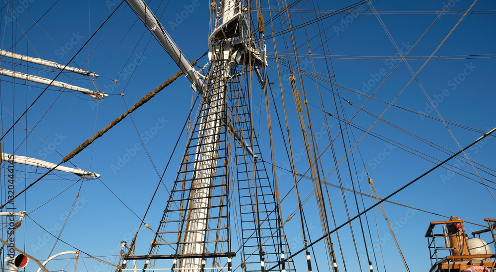 Ratlines on a classic sailing tall ship, visible mast, yards, rigging