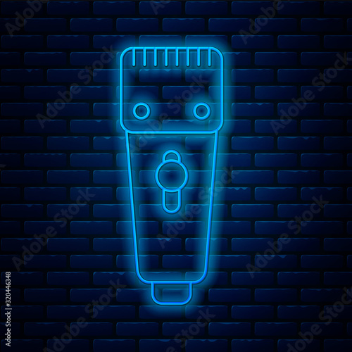Glowing neon line Electrical hair clipper or shaver icon isolated on brick wall background. Barbershop symbol. Vector Illustration