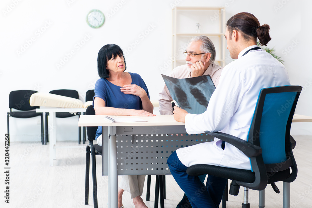 Old couple visiting young male doctor Old couple visiting young male doctor