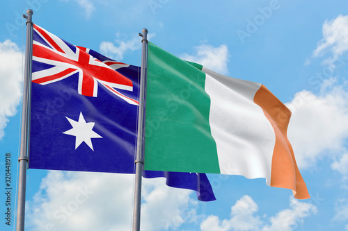 Tableau sur toile Ireland and Australia flags waving in the wind against white cloudy blue sky together