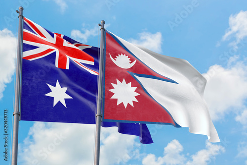 Bild auf Leinwand Nepal and Australia flags waving in the wind against white cloudy blue sky together