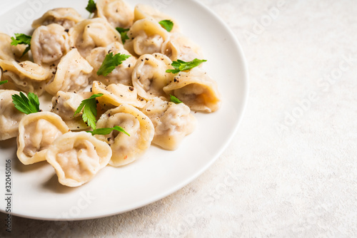 Pelmeni Russian national kitchen. Boiled dumplings with beef. Selective focus. Shallow depth of field.