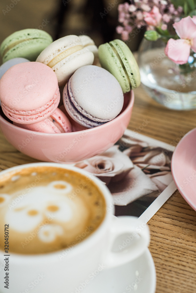 Multi-colored macaroons on a plate in a cafe on the table Multi-colored macaroons on a plate in a cafe on the table