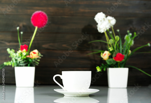 Wallpaper Mural Coffee cup and Artificial flower vase bouquet over table Torontodigital.ca