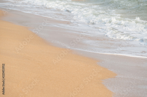 Soft foam wave and sea on the sandy beach