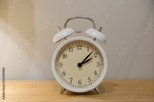 Alarm clock on the wood table beside the bed