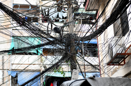 Power line cables, telephone wires get tangled in a mess on the power pole