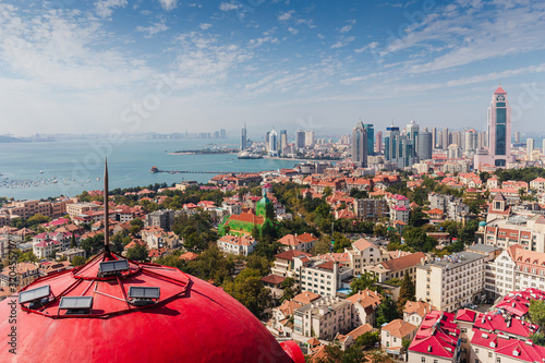 Top view from the hill of Signal Park of red roofs and cityscape of old town and new town seaside of Qingdao, China.Seaside tourist town that is popular with Chinese people. photo