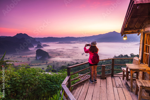 Young gril in red jacket hiking on Phu- lang-ka, Payao province, Thailand. photo