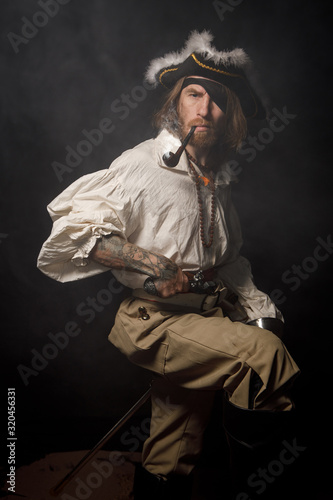 Portrait of pirate filibuster sea robber in suit with guns. Concept photo