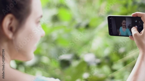 Young pretty woman takes selfie. 