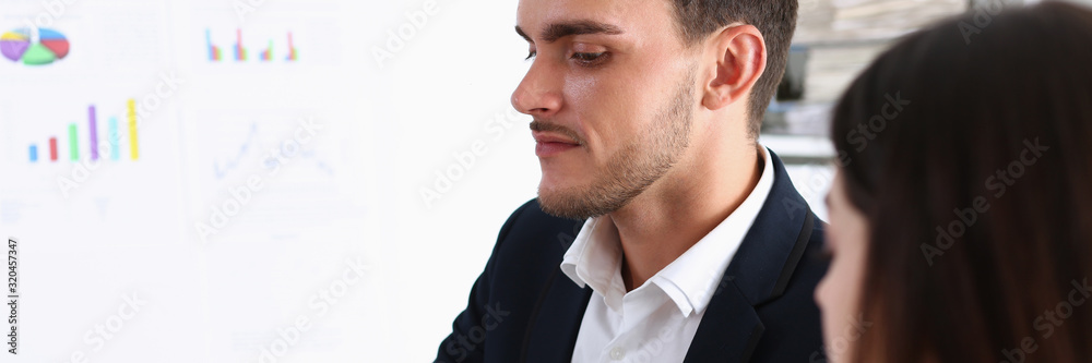 Obraz premium Group of people deliberate on white board problem in office closeup. Graph consult idea participate creative talk review situation job document explain council train successful decision concept