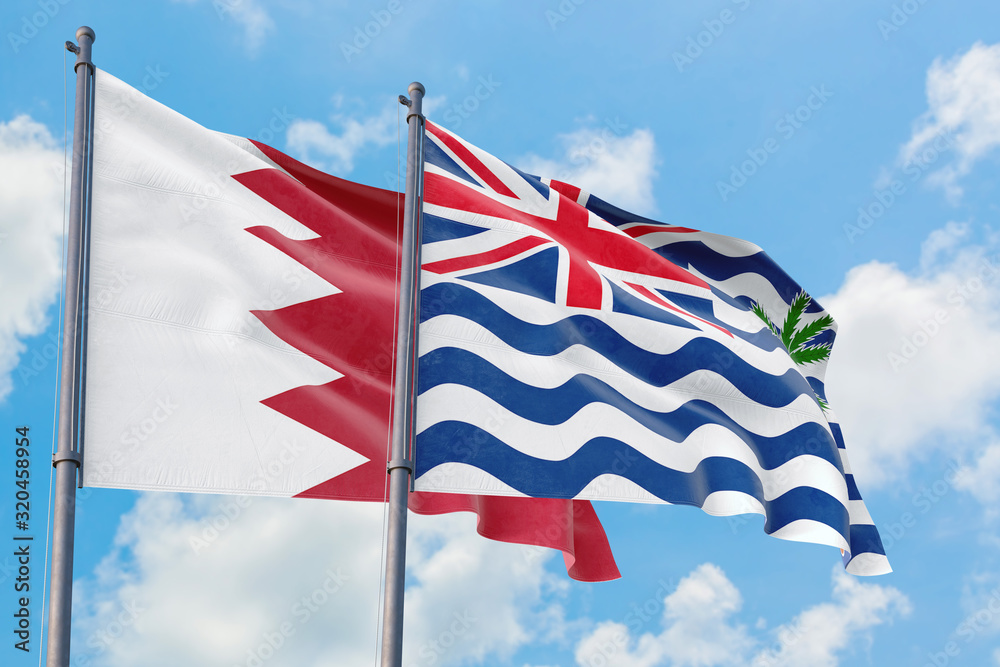 British Indian Ocean Territory and Bahrain flags waving in the wind against white cloudy blue sky together. Diplomacy concept, international relations.