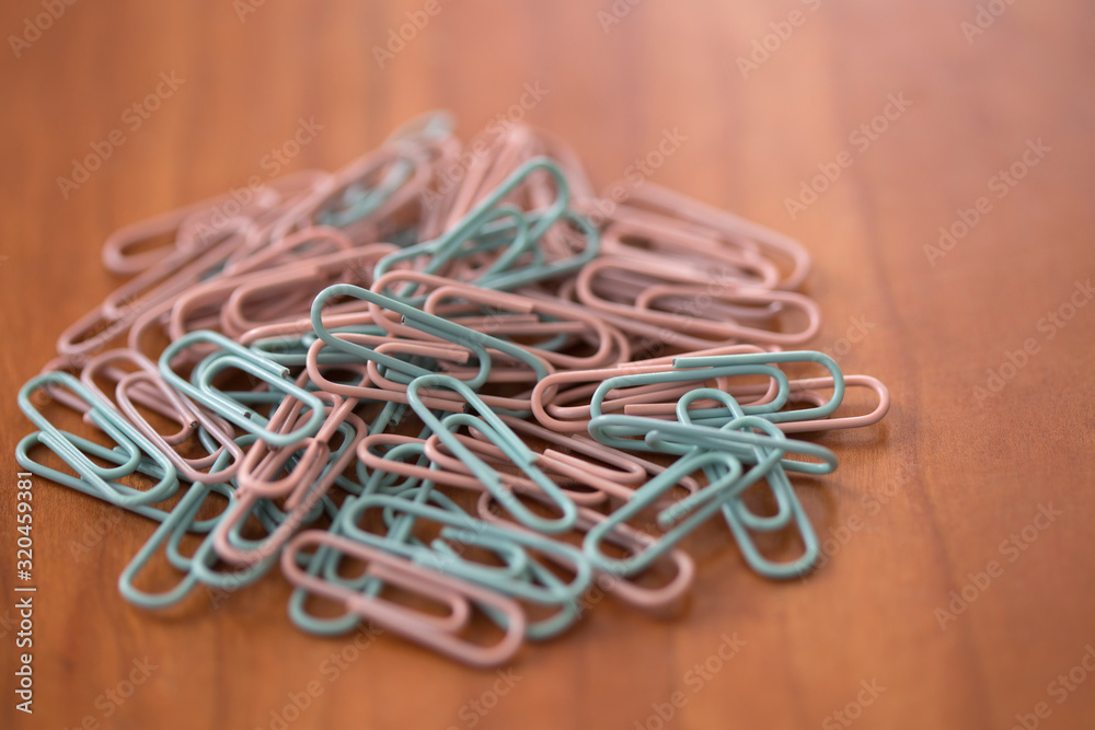 close-up paperclips on wooden desk close-up paperclips on wooden desk