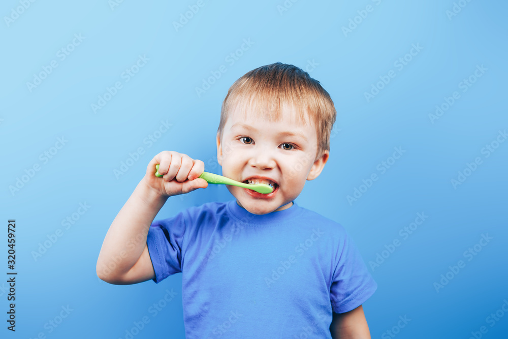 Small boy holding toothbrush and show his perfect teeth. Small boy holding toothbrush and show his perfect teeth.