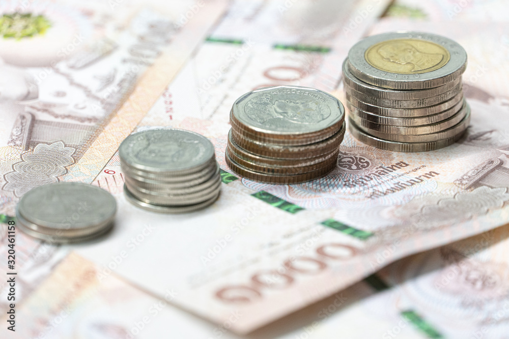 Close up bar chart from coin on Thai Bath currency money banknote. Background concept for thailand financial and  economy.