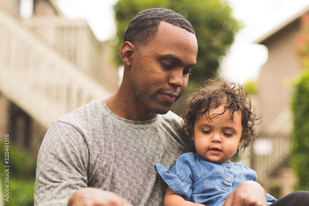 Father holding his little girl. Mixed race family. Father holding his little girl. Mixed race family.
