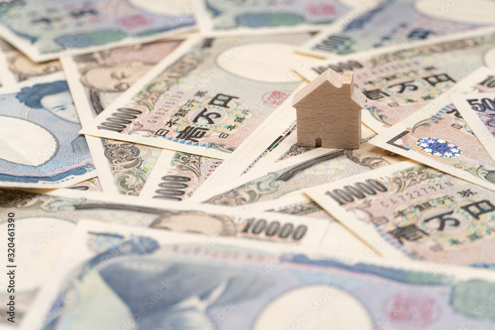 Close up little wooden house on japanese currency yen money banknote. Background concept for japan real estate industry economy. Close up little wooden house on japanese currency yen money banknote. Background concept for japan real estate industry economy.