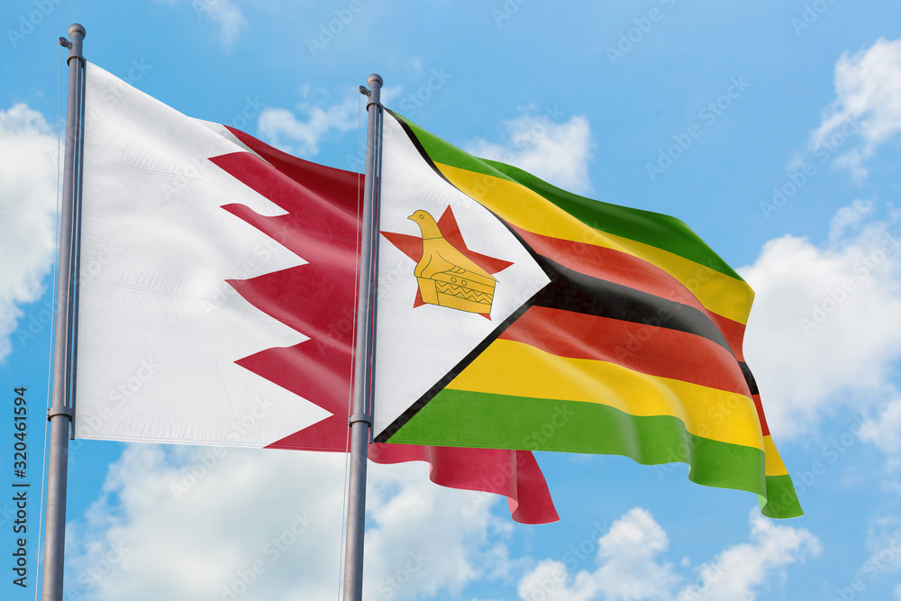 Zimbabwe and Bahrain flags waving in the wind against white cloudy blue sky together. Diplomacy concept, international relations. Zimbabwe and Bahrain flags waving in the wind against white cloudy blue sky together. Diplomacy concept, international relations.