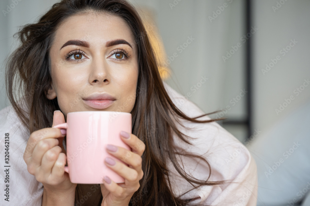 Dreamy girl holding a mug of coffee Dreamy girl holding a mug of coffee
