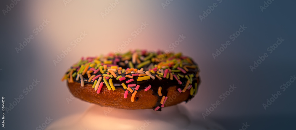 Assorted donuts with dark chocolate frosted and sprinkles on it