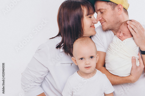 the concept of a healthy lifestyle, the protection of children, shopping - baby in the arms of the mother and wather. Woman and man holding a child
