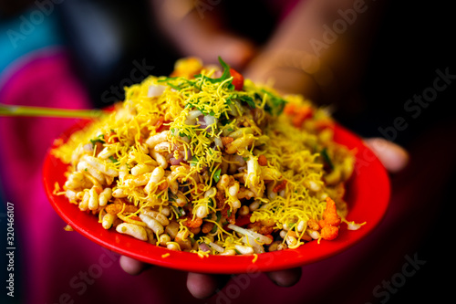 Bhelpuri an Indian chaat or snack and it is made of puffed rice, vegetables and a tangy tamarind sauce. photo