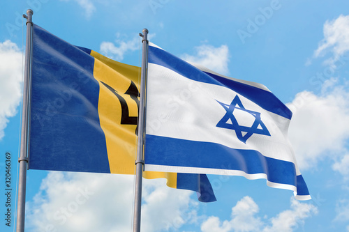 Israel and Barbados flags waving in the wind against white cloudy blue sky together. Diplomacy concept, international relations.