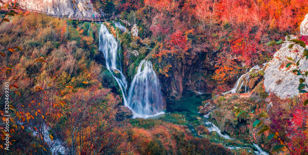 Fototapeta premium Colorful morning view of pure water waterfall in deep canyon. Amazing autumn scene of Plitvice National Park, Croatia, Europe. Beauty of nature concept background.