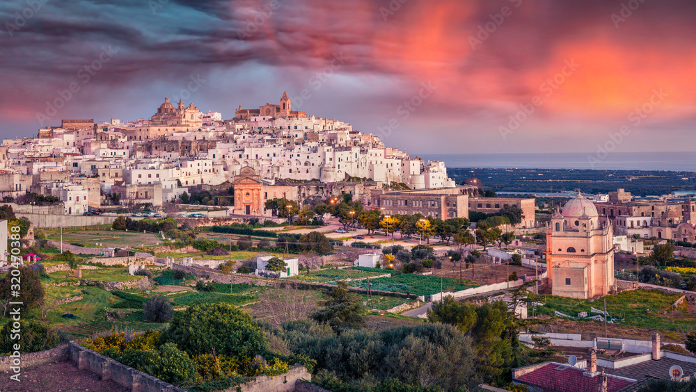 Fantastic morning cityscape of Ostuni town. Adorable spring sunrise in Apulia, Italy, Europe. Traveling concept background.