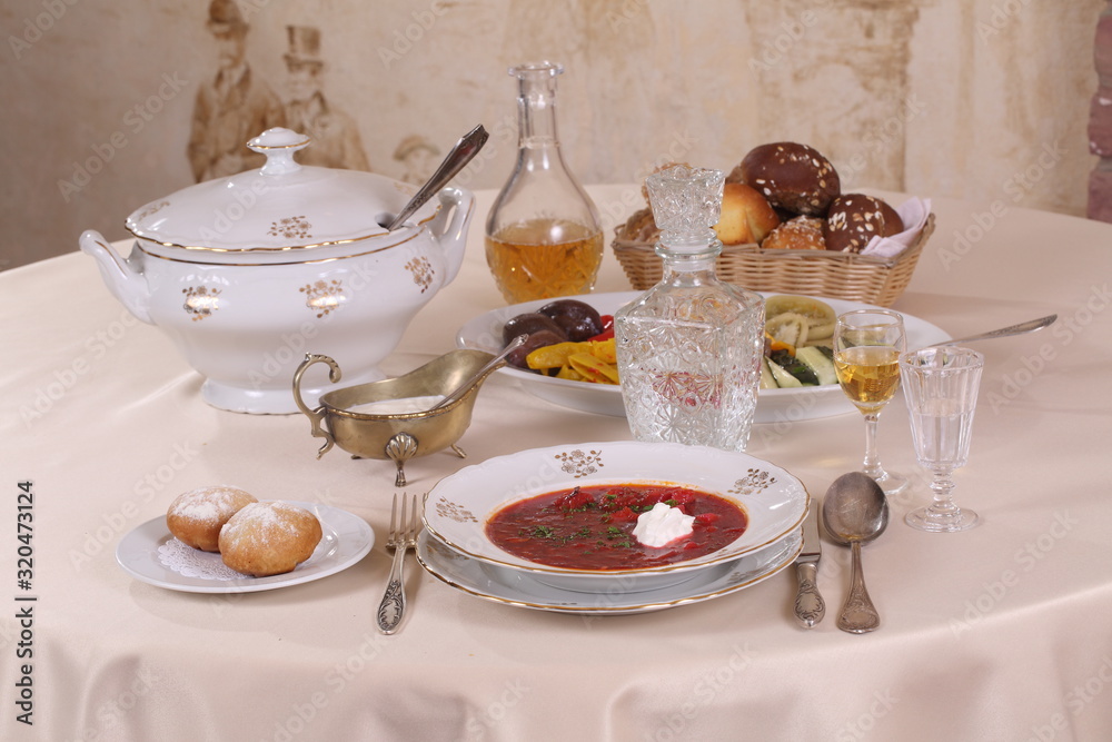 Still-life with borsch with vodka on a festive table Still-life with borsch with vodka on a festive table