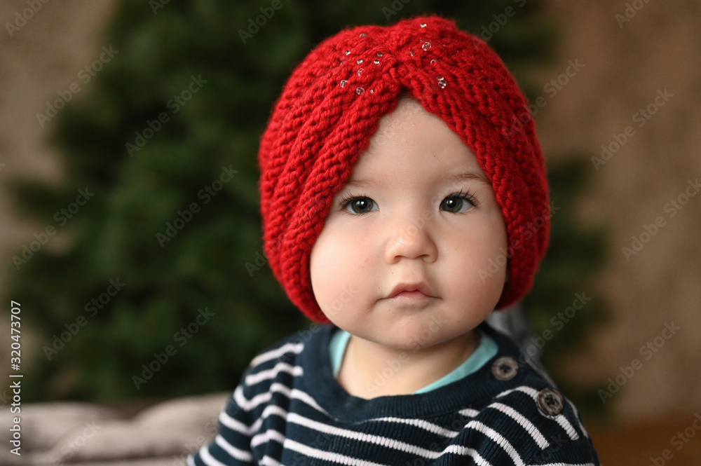 Red hat and baby. one year old child portrait. close-up. Red hat and baby. one year old child portrait. close-up.