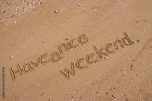inscription on the sand, Handwriting words "Have a nice weekend." on sand of beach.