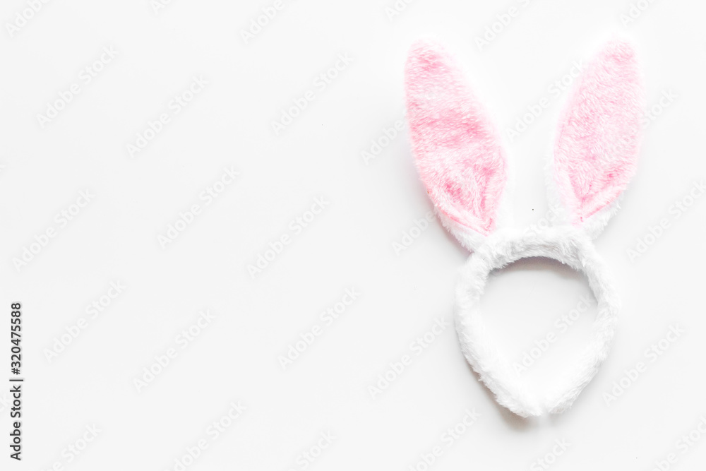 Easter bunny concept. Toy rabbit's ears for head on white background top-down copy space