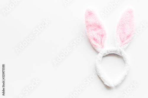 Easter bunny concept. Toy rabbit's ears for head on white background top-down copy space