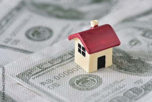 Small house on dollar bills background photo