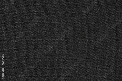 Black natural texture of knitted wool textile material background. dark gray cotton fabric woven canvas texture © Илья Подопригоров